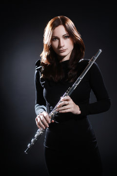 Beautiful woman flute player portrait