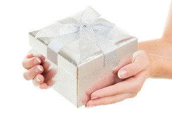 Hands holding beautiful gift box, female giving gift, Christmas