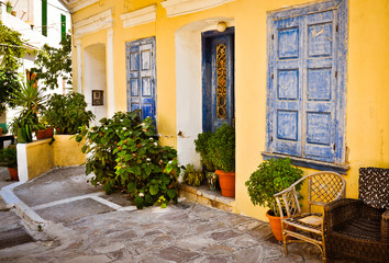 Fototapeta na wymiar Ornamental blue doors, plants and windows, Samos, Greece