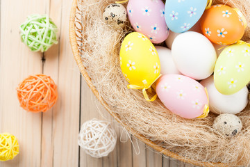 Colorful Easter eggs in the basket with colorful decorative ball