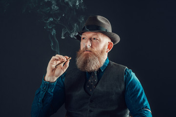 Man with Goatee in Trendy Wear Smoking a Cigarette