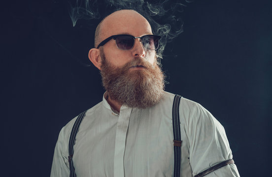 Stylish Bald Goatee Male Smoker On Gray Background