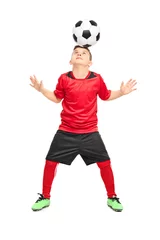 Poster Junior soccer player joggling with a ball © Ljupco Smokovski