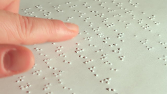 Female Hand Reading Braille