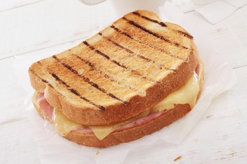 toasted cheese and ham sandwich with coffee