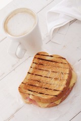 toasted cheese and ham sandwich with coffee