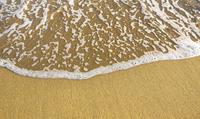 Soft wave of the sea on the sandy beach.