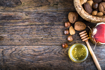 honey dipper and nuts in honey and nuts of various kinds,