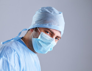 Male surgeon in mask looking at camera