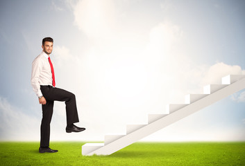 Business person climbing up on white staircase in nature