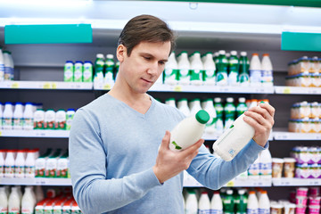 Man chooses dairy products in store