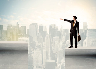 Businessman standing on the edge of rooftop