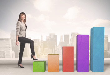 Business person climbing up on colourful chart pillars concept