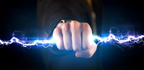 Business man holding electricity light bolt in his hands