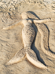 Mermaid made of sand on the beach.