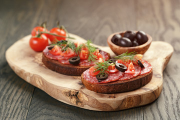 open rye sandwich with salami and vegetables