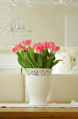 vase of tulips on table