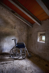 Fototapeta na wymiar Wheelchair in an attic