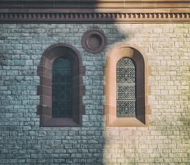 Partially sunlit windows of an old church