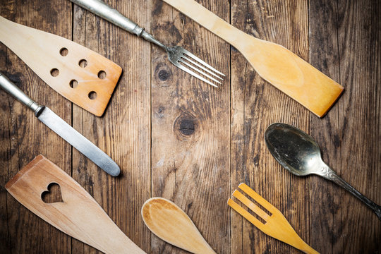 Wood and metal utensils, wooden table.