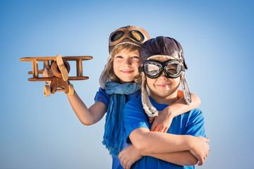 Happy children playing with toy airplane