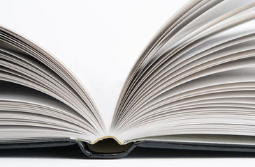 Open book with black hardcover isolated on white.