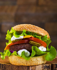 Big burger with beef cutlet and fresh vegetables