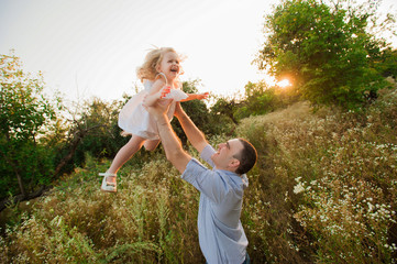 Healthy Father and Daughter Playing Together at Sunset.
