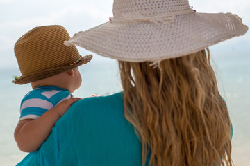  mother and baby hat hugging beach