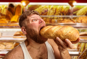Man eating bread in the shop