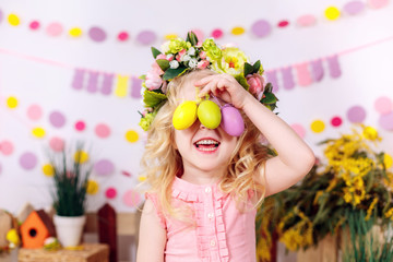Fototapeta na wymiar happy little girl with easter eggs, smiling, easter decor