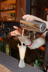 Bartender is making whisky sour