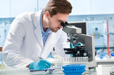 Scientist looking through a microscope in a laboratory