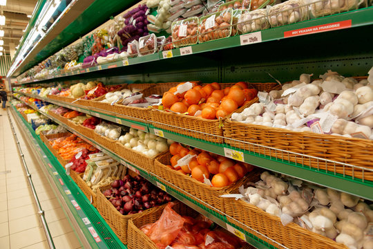 Onion and garlic on supermarket shelf, no trademarks