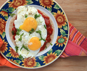 Huevos rancheros in colorful sunflower plate - 79791293