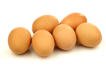 bunch of brown eggs on a white background