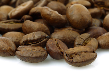 bunch of fresh coffee beans on a white background