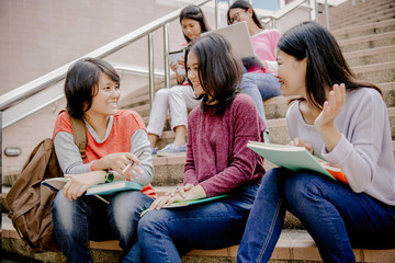 group of happy teen high school students outdoors