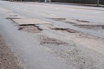 Big hole in street asphalt