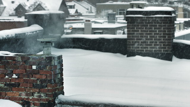 chimney blowing smoke in the winter