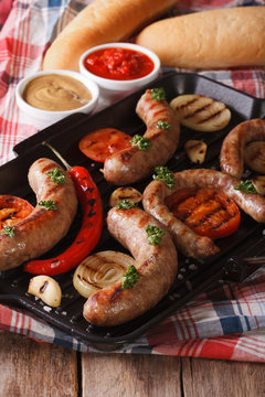 sausage with grilled vegetables and buns, sauce. Vertical