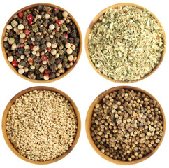 Fototapeta premium Different spices in bowls isolated on white