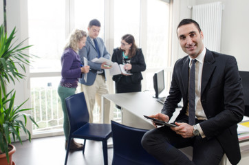 Businessman with people in background