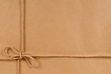 Brown paper package parcel background tied with string or rope photo