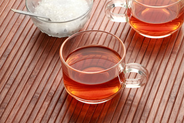 Tea Cup and Sugar in wooden background