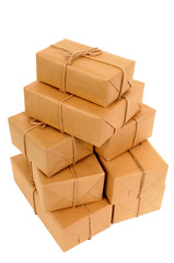 Tall stack or pile of several various brown paper package or parcel for delivery isolated on white background photo vertical