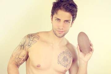 handsome male holding a Easter egg