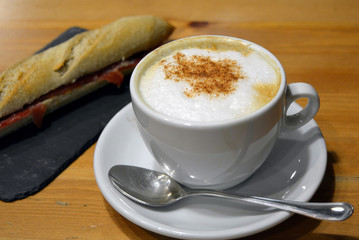 Prosciutto sandwich with cup of cappuccino