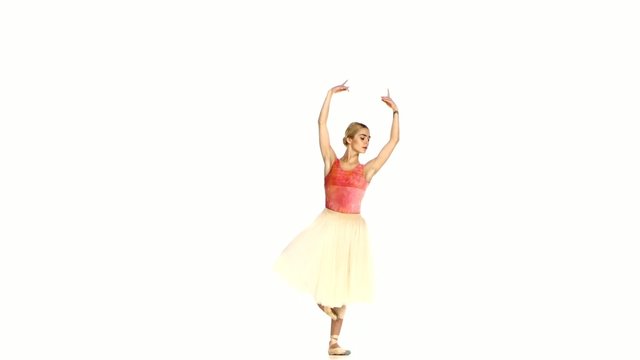 Young ballerina making dance trick, grands battements, on white