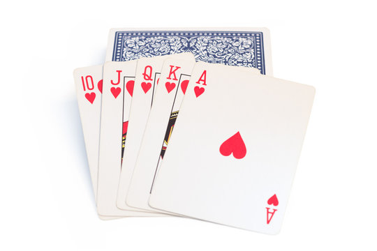 Playing cards on top of stack of cards, isolated on white